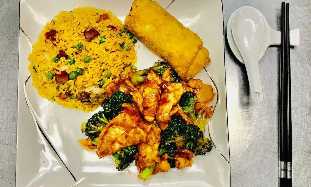 Fried Rice and Egg Roll Yellow fried rice with peas and ham, egg roll, chicken and broccoli stir-fry at Double Delight, a Chinese Restaurant restaurant in Brooklyn
