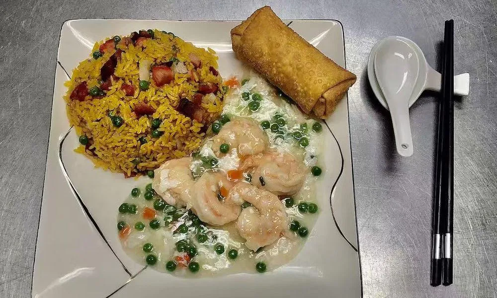 Fried Rice with Shrimp and Spring Roll Yellow rice with peas, shrimp, carrots, and a crispy spring roll at Double Delight, a Chinese Restaurant restaurant in Brooklyn